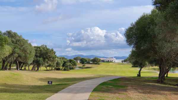 A wide angle landscape photo of a golf course.