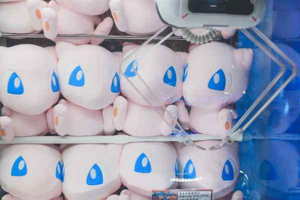 Mew plushies crammed together in a claw machine game.